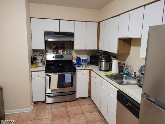 a kitchen with a stove and a refrigerator