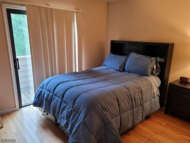 a large bed sitting in a bedroom next to a window