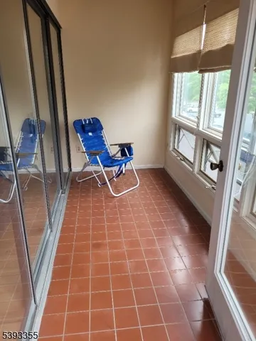 a room with gym equipment and a rug