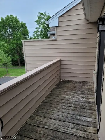 a view of a terrace with bench and trees