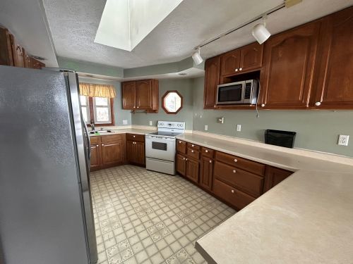 10940 South Dwight Road Dwight, IL 60420 - Photo 11 of 20 a kitchen with stainless steel appliances granite countertop a sink stove and microwave
