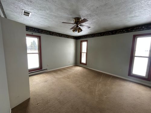 10940 South Dwight Road Dwight, IL 60420 - Photo 14 of 20 an empty room with windows and fan