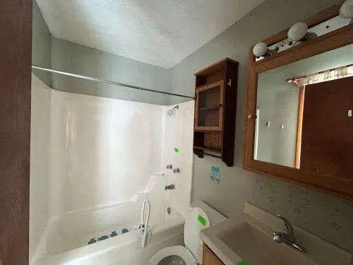 a bathroom with a sink and mirror