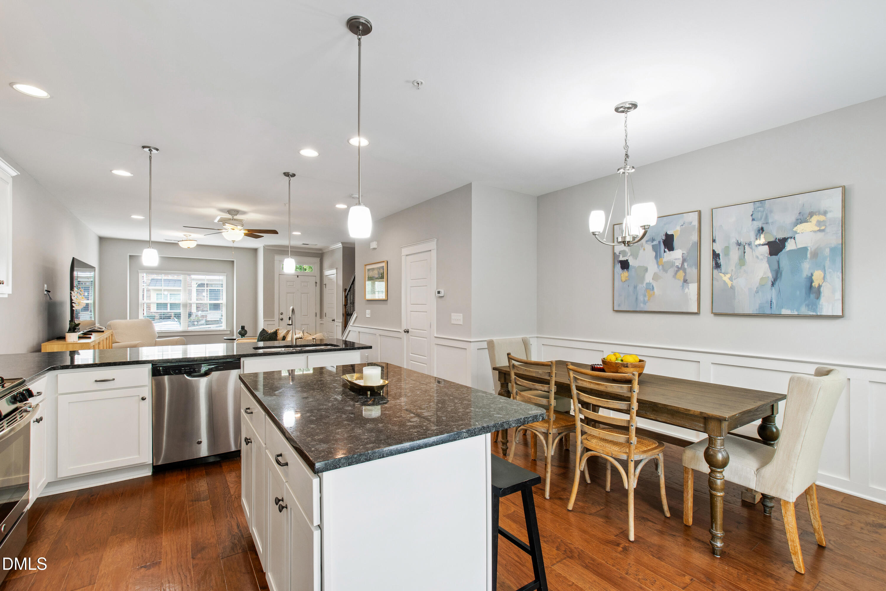 6246 Pesta Court Raleigh, NC 27612 - Photo 12 of 37 a kitchen with a table chairs stove and cabinets