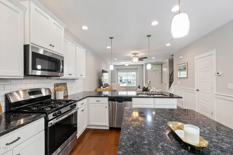 a kitchen with sink stove and cabinets