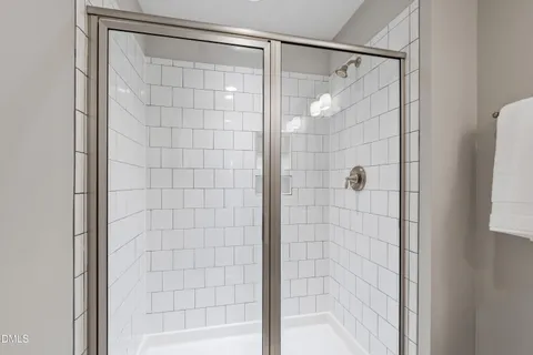 a bathroom with a glass shower door