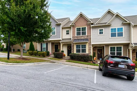 a view of a house with a swimming pool and sitting area