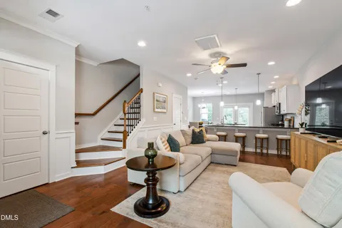 a living room with furniture and a chandelier