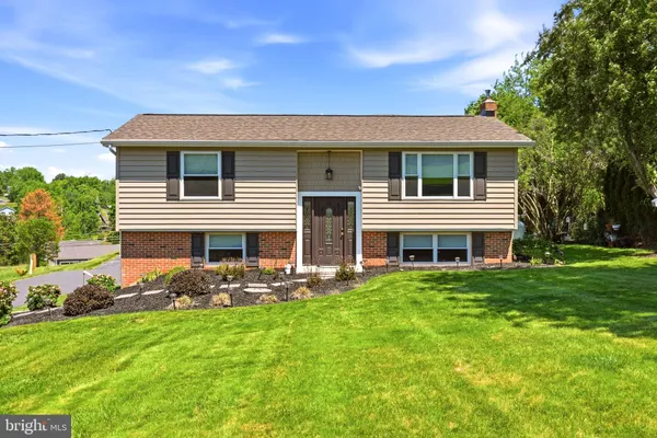 a front view of house with yard and green space