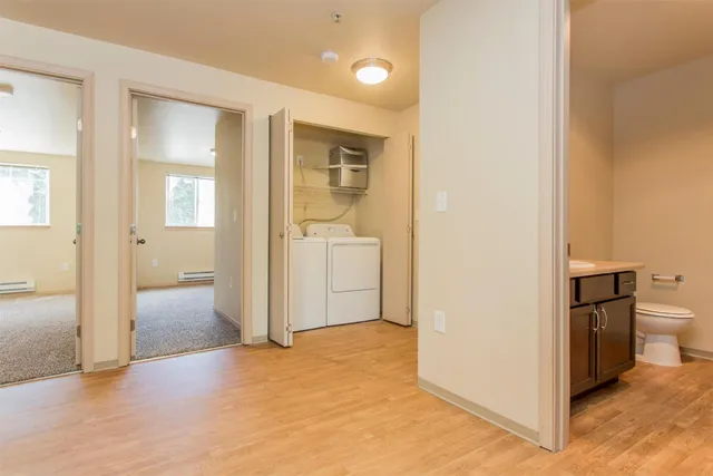 a view of a bathroom with toilet shower and a sink