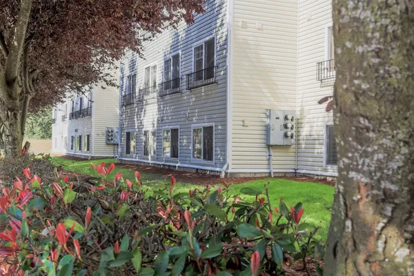 a view of a house with a flower garden