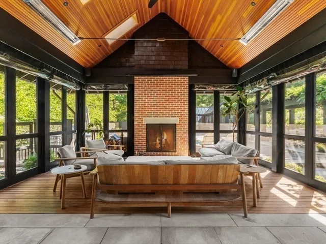 a living room with furniture and a floor to ceiling window