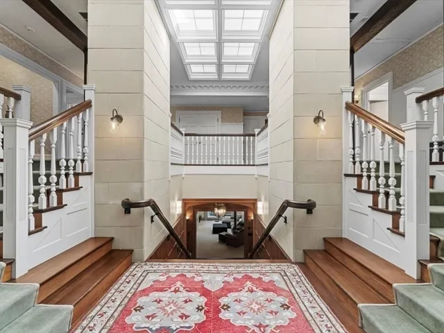 a living room with furniture a rug and a fireplace