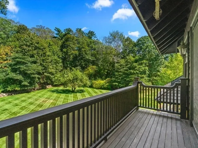 a balcony with trees in front of it