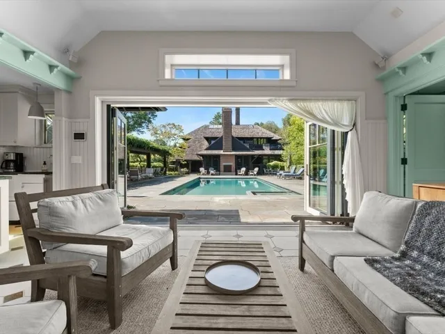 a living room with furniture and a floor to ceiling window