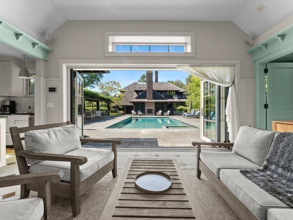 159 Bridge Street Manchester, MA 01944 - Photo 28 of 42 a living room with furniture and a floor to ceiling window