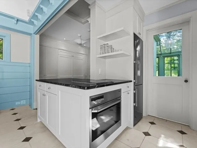a stove top oven sitting inside of a kitchen