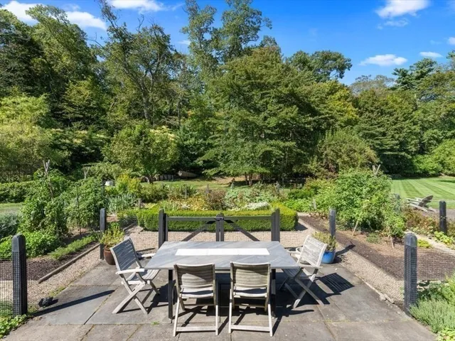 a view of a yard with furniture and a garden