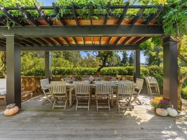 a table and chairs sitting in front of a yard