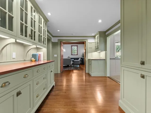 a kitchen with cabinets and wooden floor