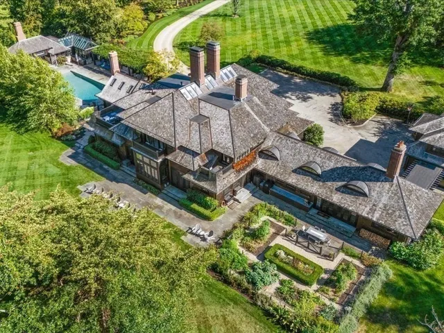 an aerial view of a house with a garden and swimming pool