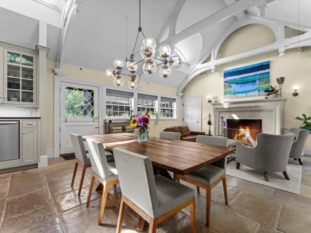 a view of a dining room with furniture a chandelier and wooden floor