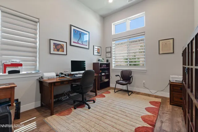 a view of a workspace with furniture and a window