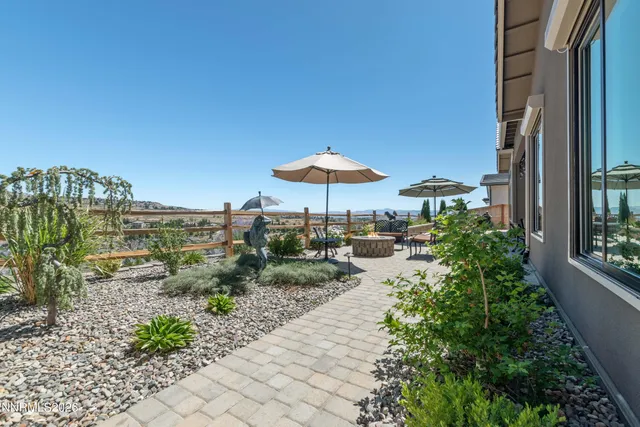 a view of a terrace with furniture and umbrella