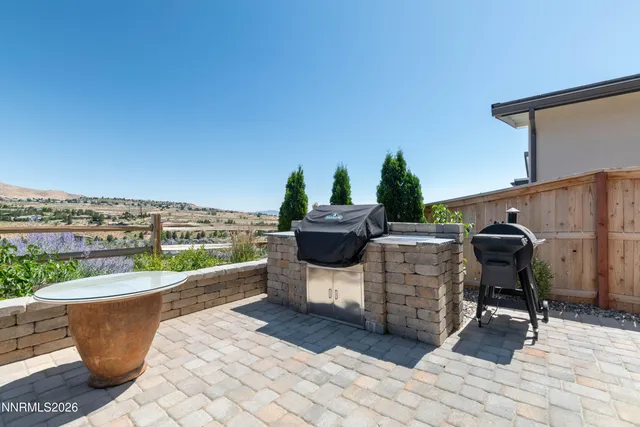 a view of a patio with a dining table and chairs