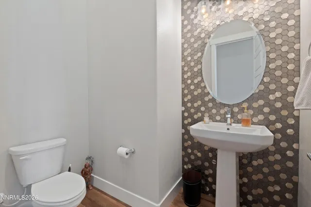 a bathroom with a sink toilet and a mirror