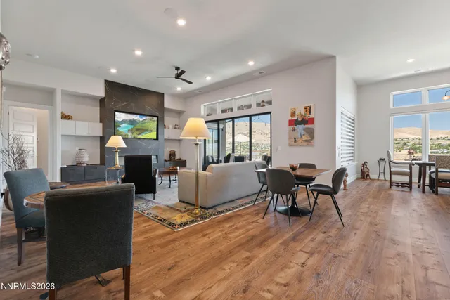a living room with fireplace furniture and a wooden floor