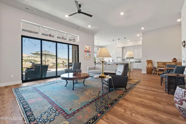a living room with furniture and a floor to ceiling window