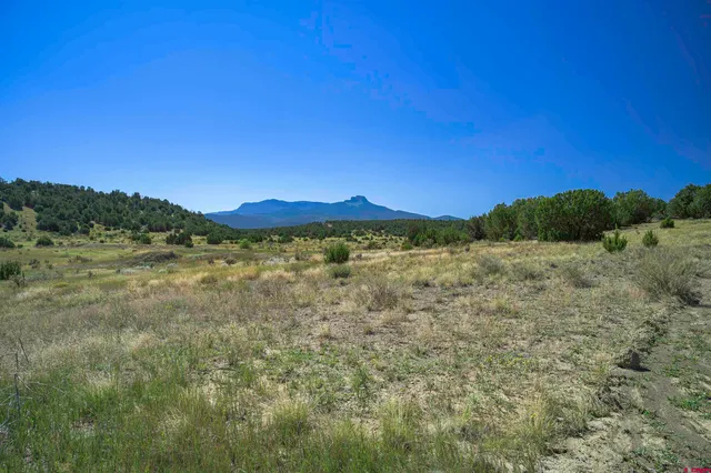 a view of a large mountain with mountains in the background