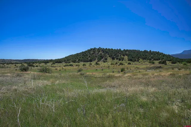 a view of a large mountain with a mountain in the background