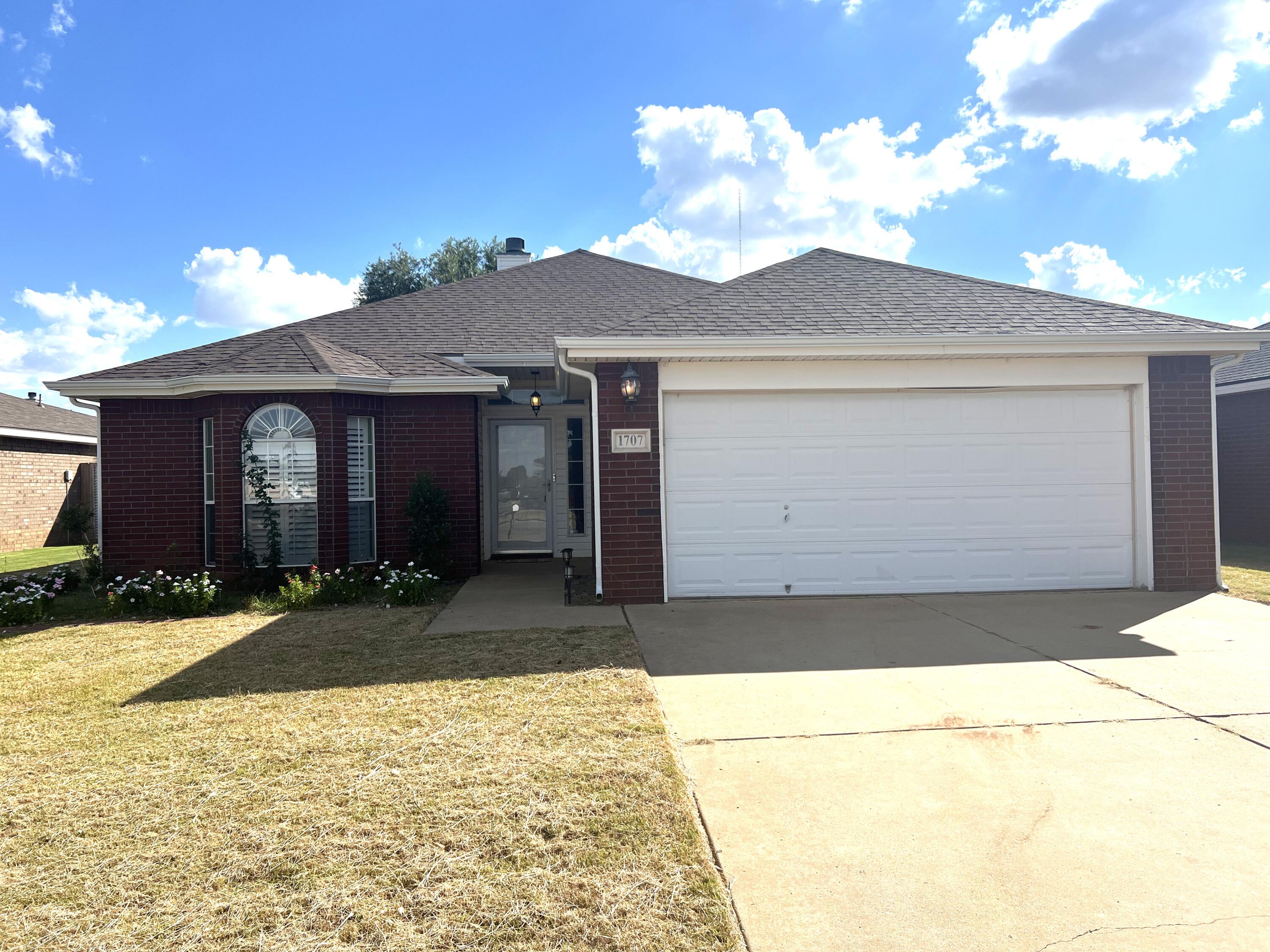 1707 76th Street Lubbock, TX 79423 - Photo 1 of 19 a front view of a house with a yard