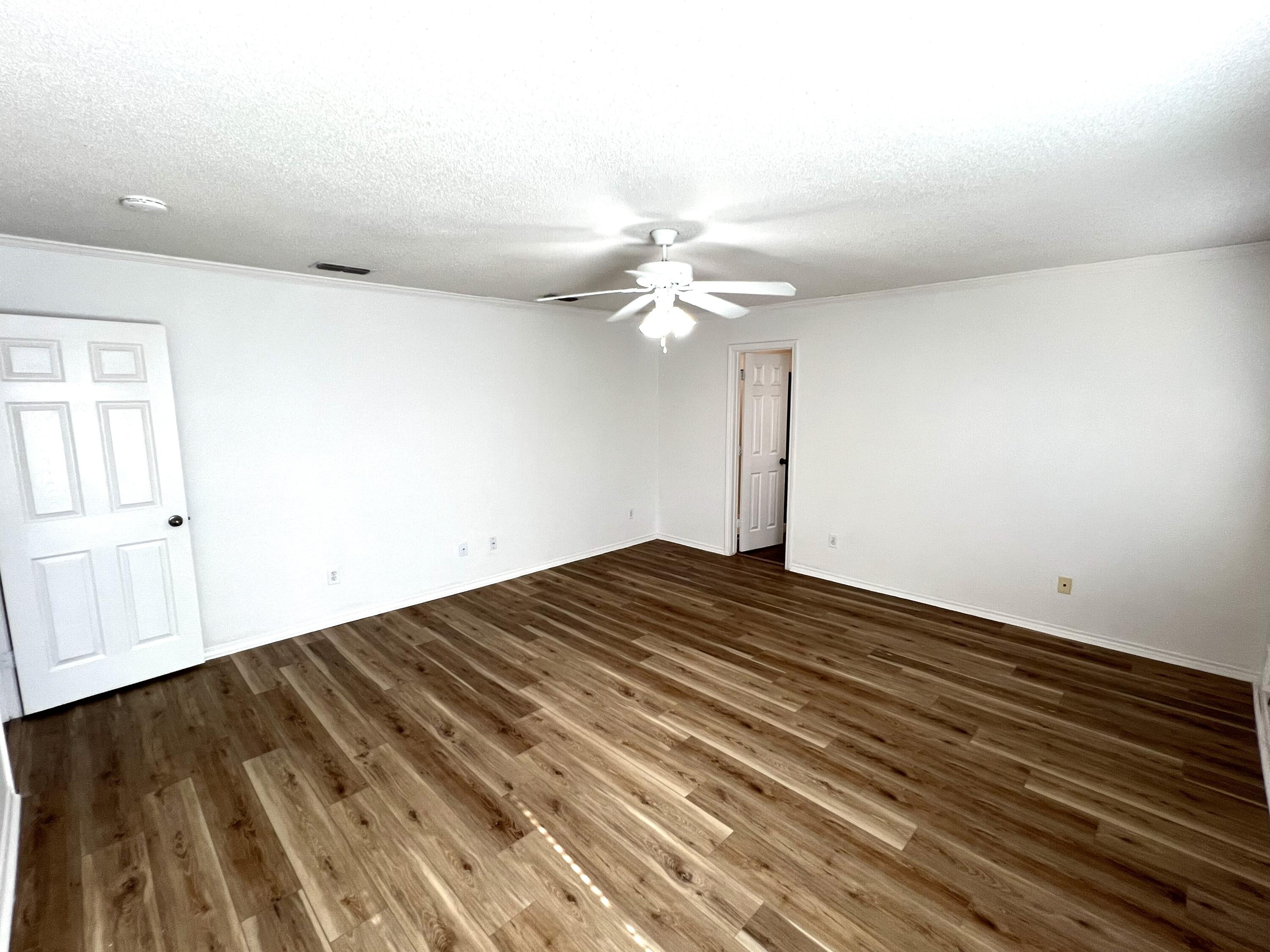 1707 76th Street Lubbock, TX 79423 - Photo 14 of 19 a view of a room with wooden floor and ceiling fan