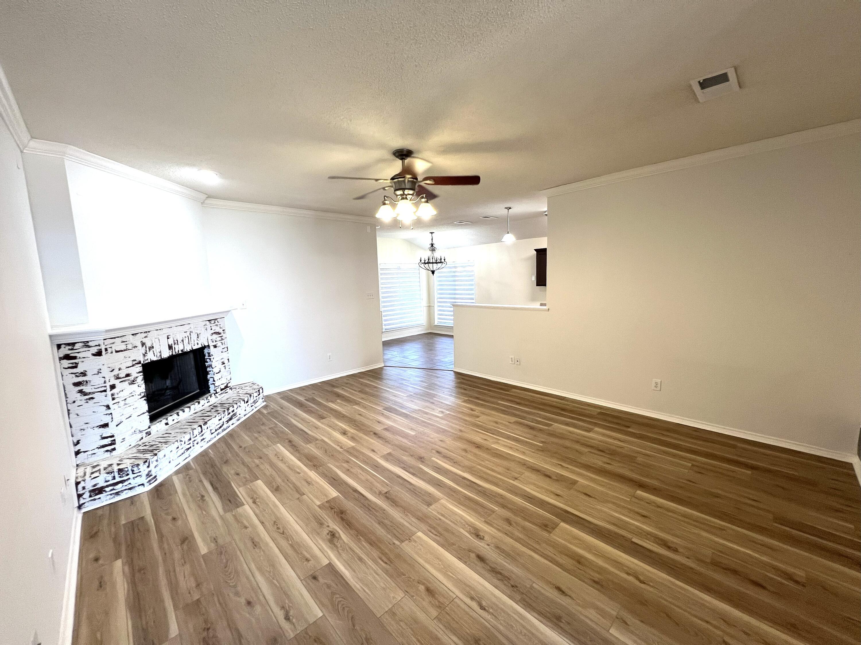 1707 76th Street Lubbock, TX 79423 - Photo 9 of 19 a view of a kitchen with a stove cabinets and wooden floor