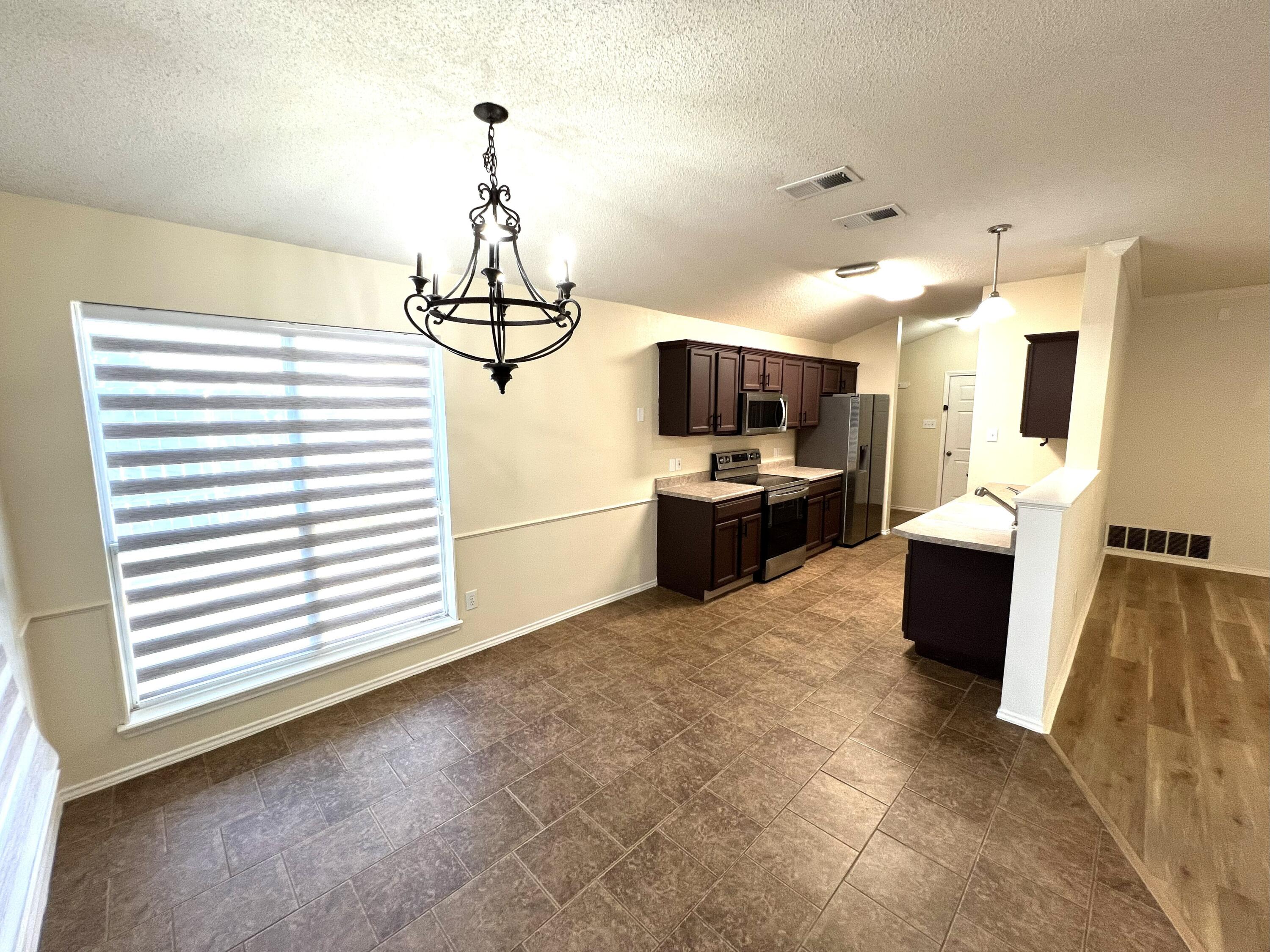 1707 76th Street Lubbock, TX 79423 - Photo 10 of 19 a view of living room with furniture and flat screen tv