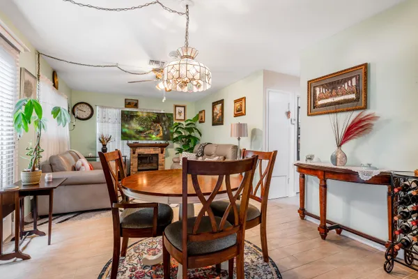 a view of a dining room with furniture and chandelier