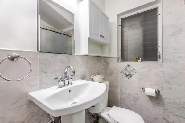 a bathroom with a sink a toilet and mirror