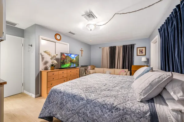 a bed sitting in a bedroom and painting on the wall