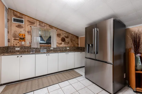 a kitchen with stainless steel appliances granite countertop a refrigerator and a sink