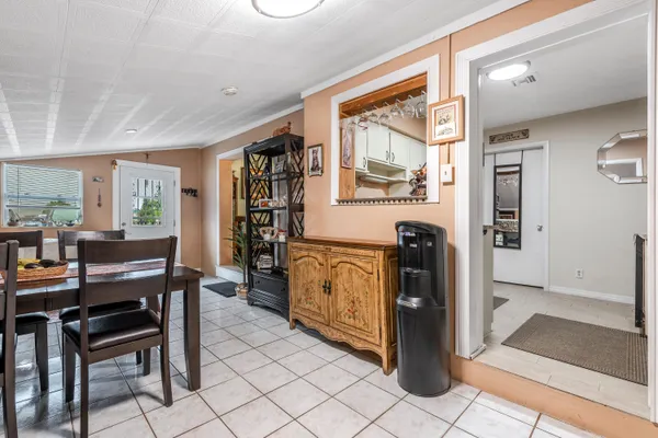 a kitchen with stainless steel appliances kitchen island granite countertop a refrigerator and cabinets