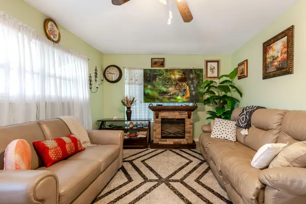a living room with furniture and a fireplace