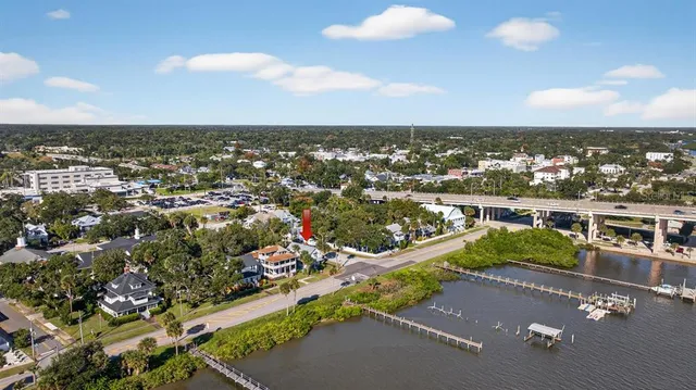 a view of a house with a swimming pool and a yard