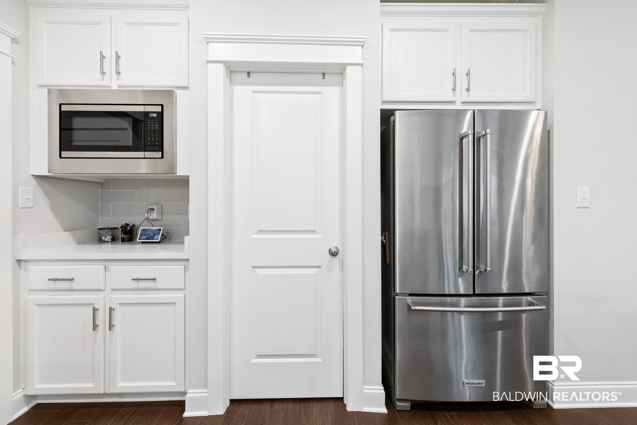 13233 Ibis Boulevard Daphne, AL 36527 - Photo 17 of 100 Kitchen featuring stainless steel appliances, white cabinetry, a built-in microwave, and wood-finish flooring