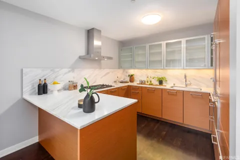 a view of a kitchen with a sink and wooden floor