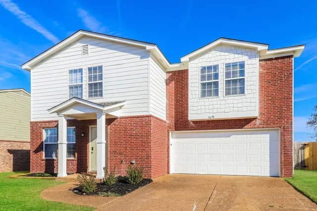 a front view of a house with a yard
