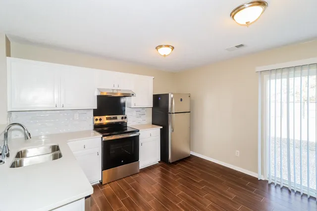 a kitchen with a sink and a refrigerator