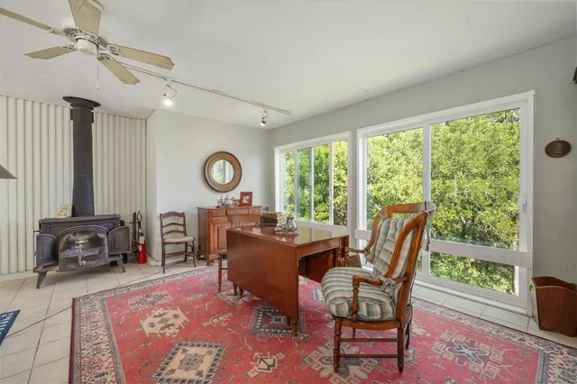a view of a workspace with furniture and a window